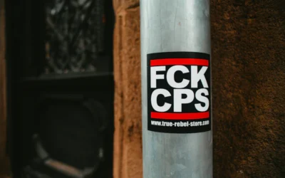 a sticker on a pole on the side of a building
