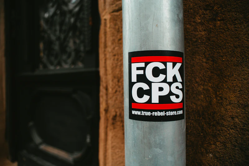 a sticker on a pole on the side of a building