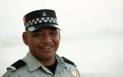 A smiling officer wearing a uniform.