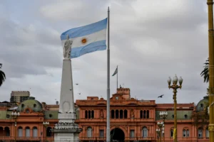 Argentinian flag waving near a prominent building.