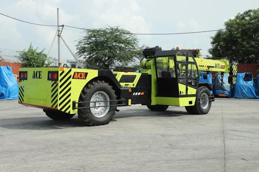 ACE TX 150 hydraulic crane photographed in an outdoor industrial setting in Faridabad, India.