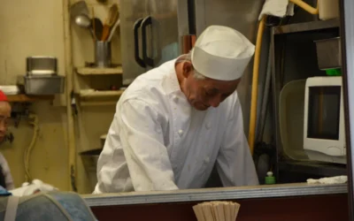 man in white chef uniform sitting on train seat