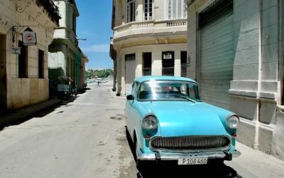 teal vehicle parked beside building