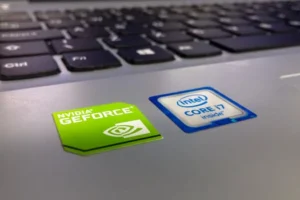 Detailed close-up of a laptop keyboard featuring Intel Core i7 and NVIDIA GeForce stickers, highlighting technology components.
