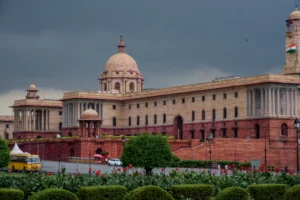 Grand sandstone building with columns and dome