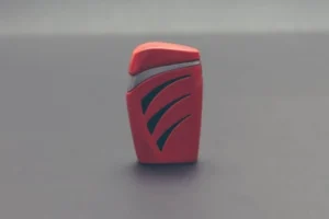 Close-up of a stylish modern red plastic lighter on a grey background, perfect for design and lifestyle themes.
