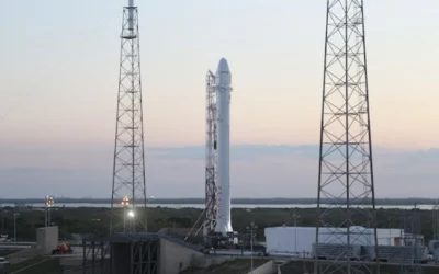 Space rocket installed on metal construction in spaceport and ready for launching against cloudless sky