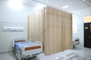 Quiet hospital ward with beds and privacy curtains in Surabaya, Indonesia.