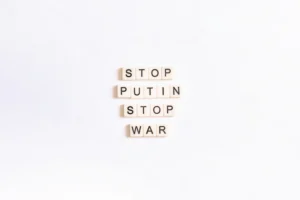 scrabble tiles spelling stop, puttin, stop, war