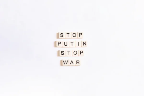 scrabble tiles spelling stop, puttin, stop, war