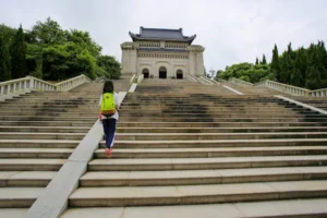 A child with a backpack ascends the stairs to the historic Sun Yat-sen Mausoleum in Nanjing.