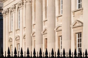 Detailed view of a neoclassical building facade with columns in Cambridge, UK.