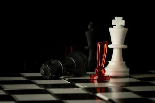 Black king lies defeated on a checkerboard, highlighting a pivotal moment in a chess match.