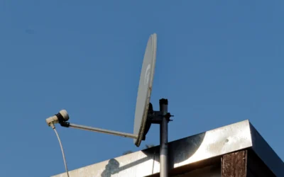 a satellite dish mounted to the side of a building