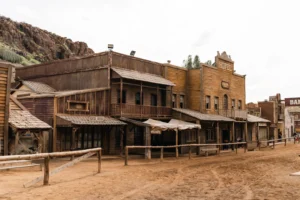Old wooden buildings line a dusty street.