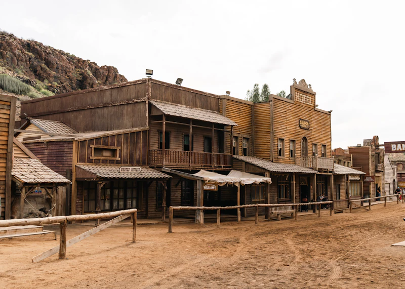 Old wooden buildings line a dusty street.