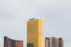 gold-colored Trump high-rise building between of two gold-colored buildings