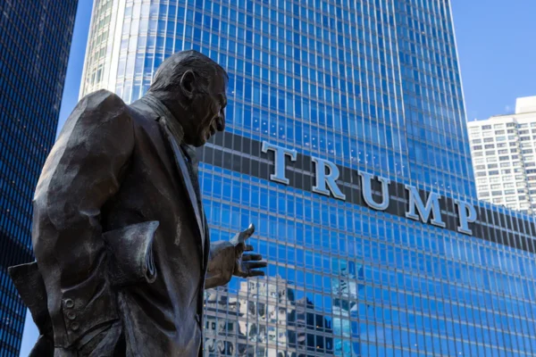 A statue overlooks the trump building.