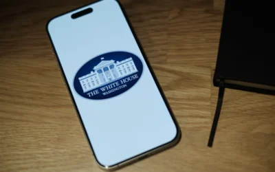 A cell phone sitting on top of a wooden table
