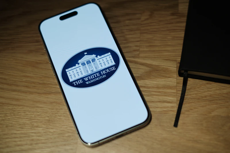 A cell phone sitting on top of a wooden table