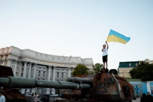 a person standing on a cannon holding a flag
