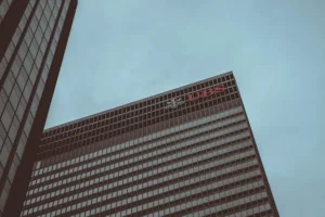 Modern skyscraper featuring the UBS logo against a clear sky in New York City.