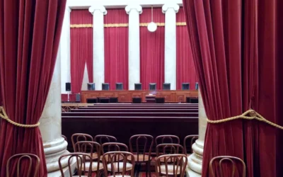 a room with red curtains and chairs in it