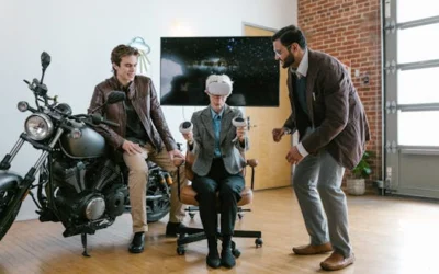 Two men assist a seated colleague with a virtual reality headset in a stylish, brick-walled office.
