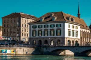 Scenic view of Zürich's historic waterfront and architectural charm on a sunny day.