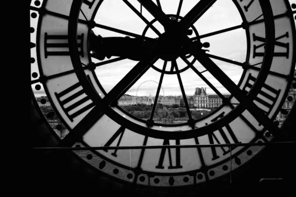 A black and white photo of a large clock