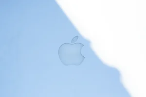 The apple logo on a blue surface.