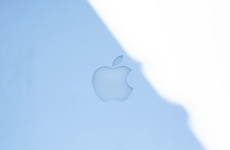 The apple logo on a blue surface.