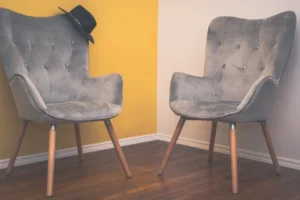 gray padded chair on brown wooden floor