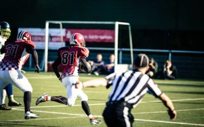 Intense action shot of American football players running on a field during a competitive game.