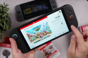 A hand is holding a nintendo switch handheld.
