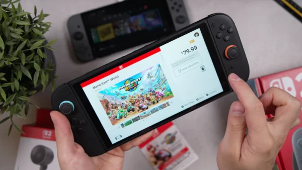 A hand is holding a nintendo switch handheld.