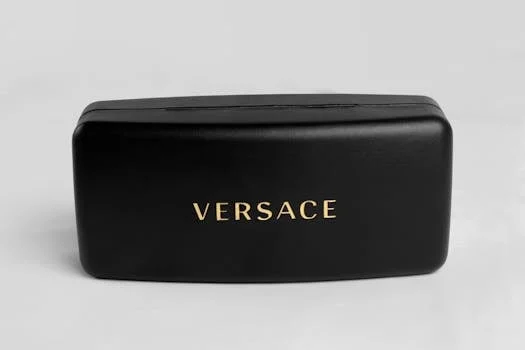 Sleek and luxurious black eyeglass case featuring the elegant Versace logo.
