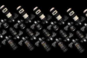 Top view of multiple DSLR cameras with lenses on a black surface. Perfect for tech and photography themes.