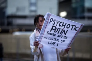 Woman holds protest sign against putin